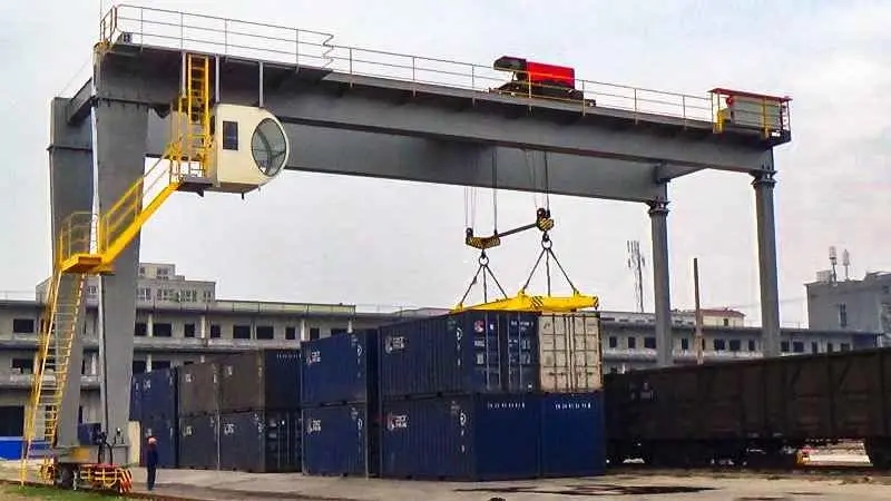 A double girder gantry crane lifts a container onto the platform