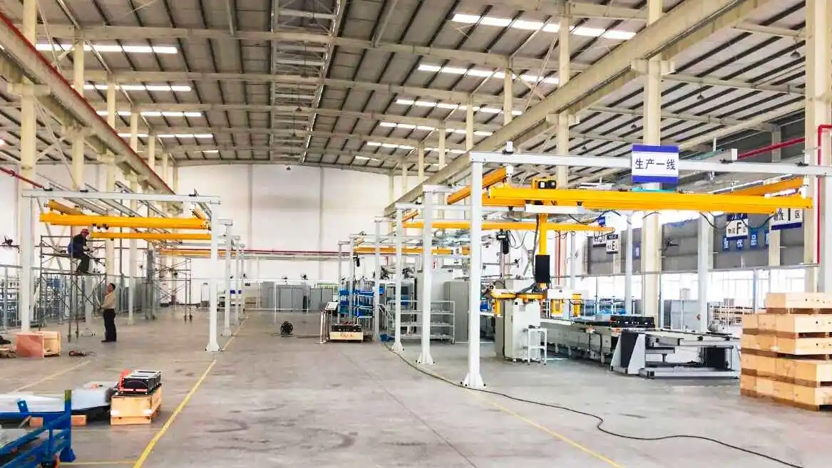 KBK Light Crane System in use at a factory with a large warehouse and a crane