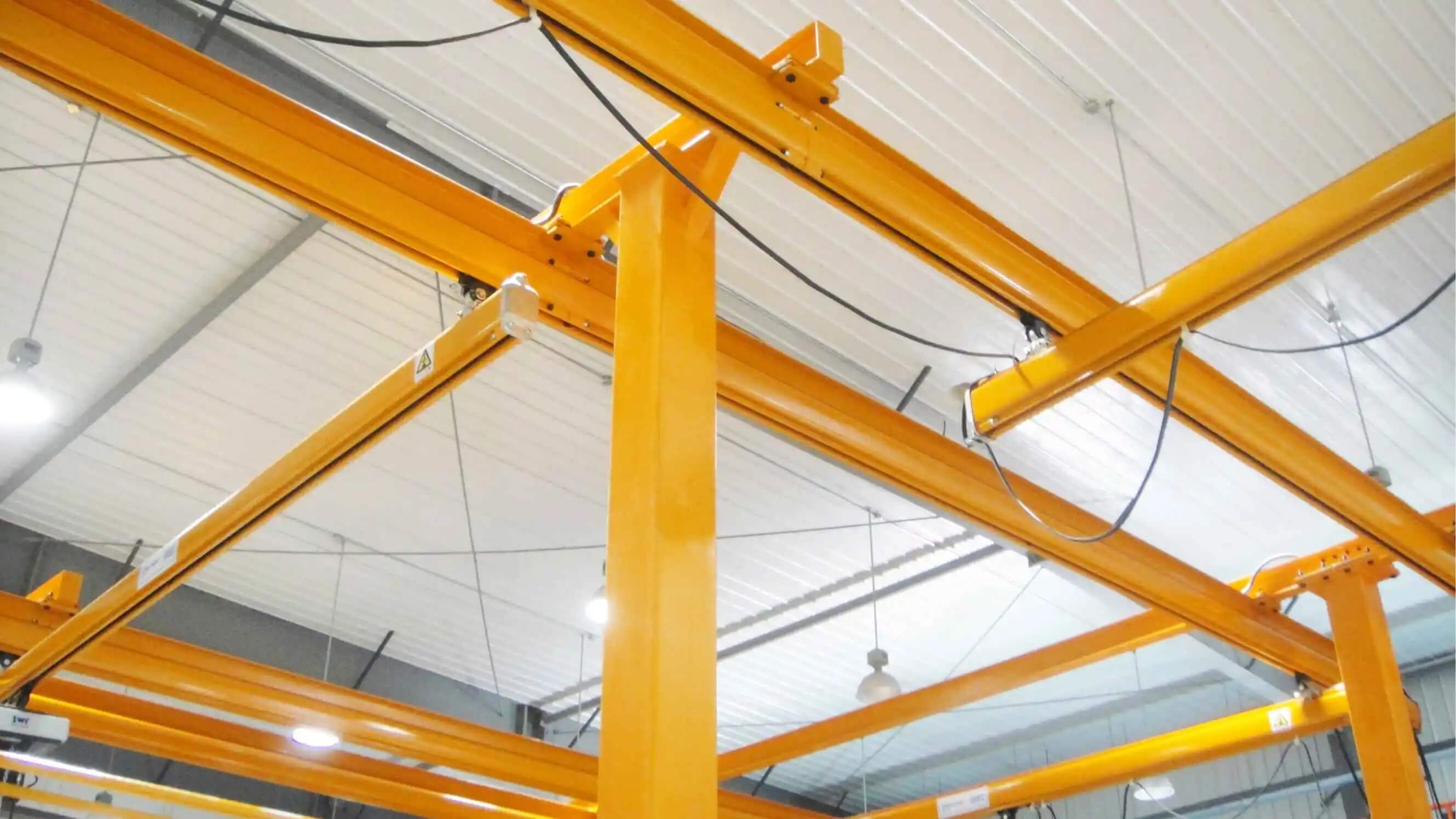 Yellow steel structure in warehouse, part of KBK Light Crane System